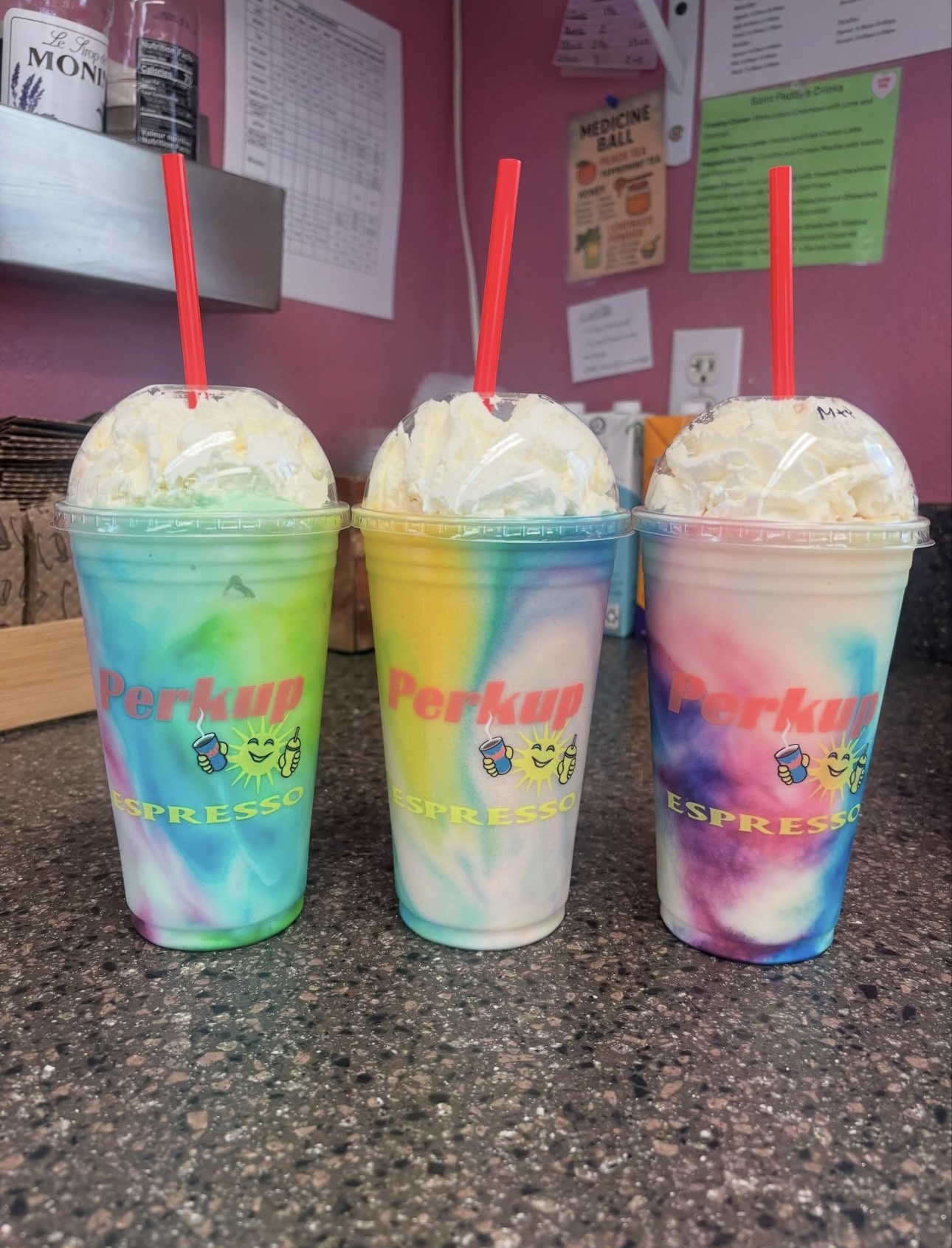 Three tie-dye Perkup Espresso smoothies on the counter